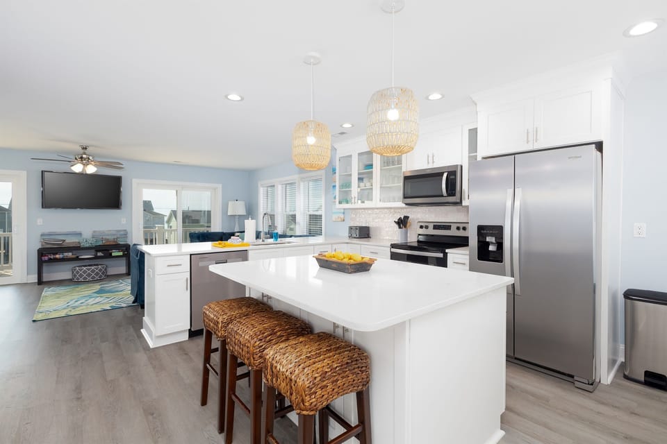Open-concept living space featuring a sleek kitchen and adjacent living area brings the whole group together