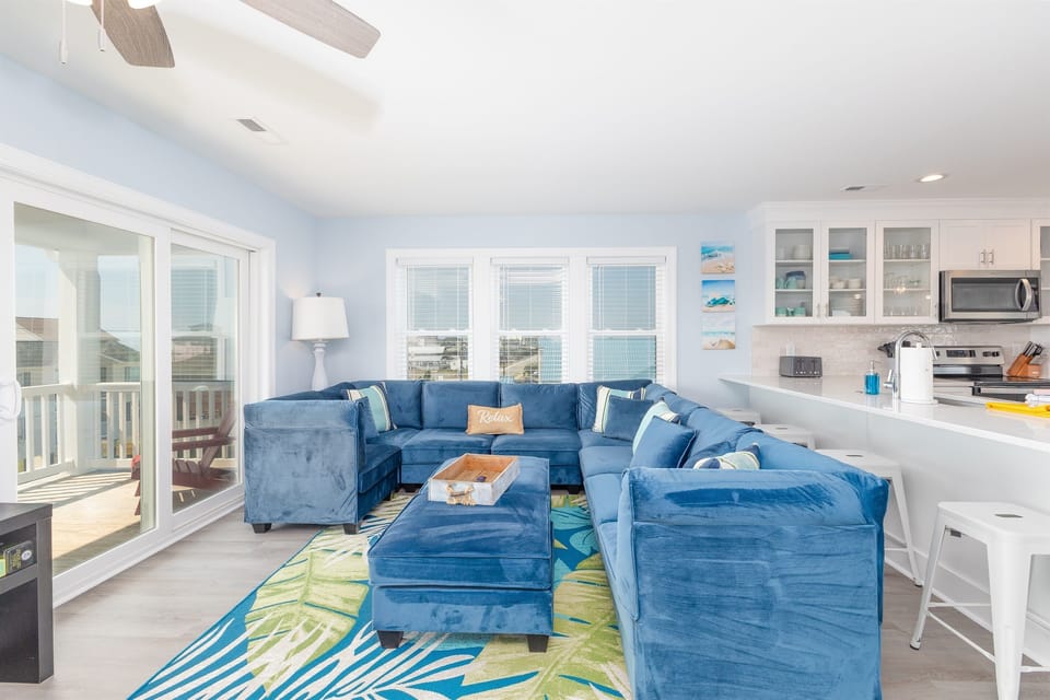 A large plush sectional with peek-a-boo ocean views - the ultimate spot for relaxation after a long day on the beach