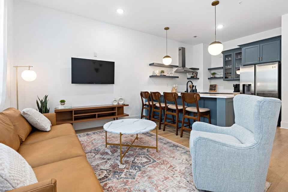 Condo 1 - Lots of natural light in the living room with a Smart TV & all the streaming apps. Open floor plan flows into the kitchen area.