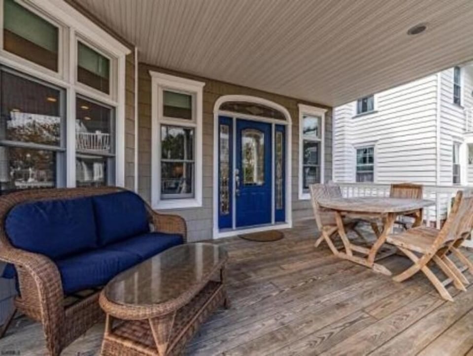 Spacious porch with outdoor dining and furniture
