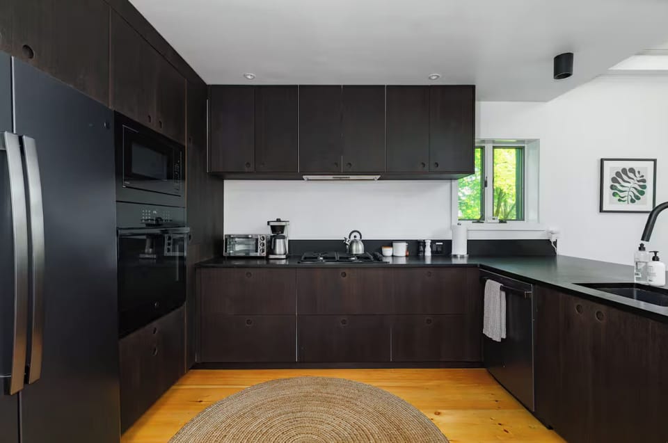 The kitchen area is open to the dining area, perfect for family gatherings! (Please know the dishwasher is currently unavailable)