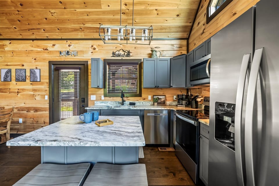 Pull up a stool for coffee, snacks, or a casual family dinner in the heart of the cabin.