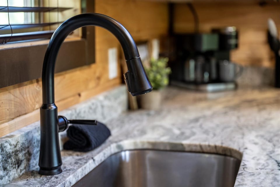 Sleek fixtures and granite countertops bring a touch of luxury to everyday meals.
