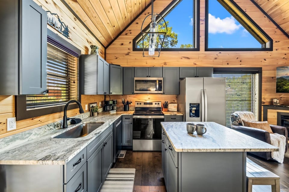 High ceilings, big windows, and modern appliances make this kitchen both stylish and practical.