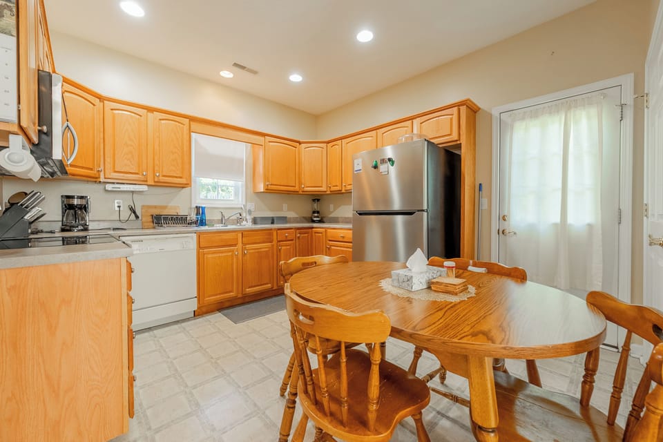 Bright kitchen with wooden cabinets and dining table