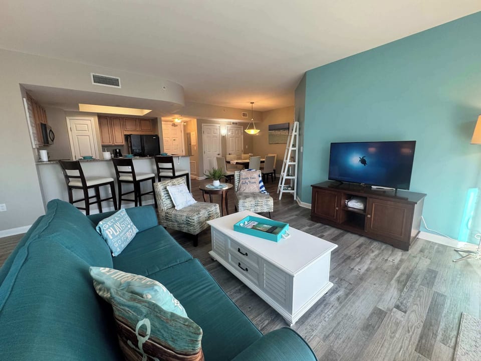 Living room with queen sleeper sofa and balcony access 