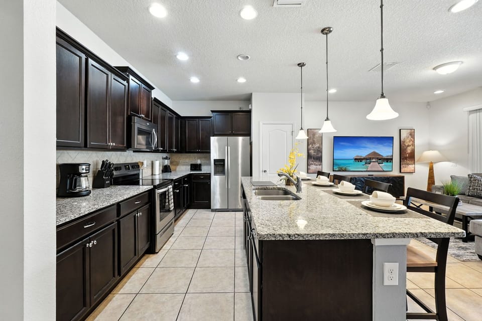 Sleek kitchen with granite countertops, stainless steel appliances, and a spacious island—perfect for cooking and entertaining!