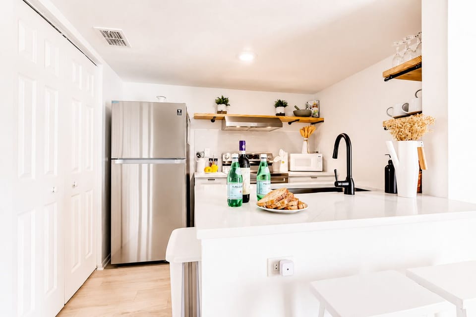 Bright modern kitchen with breakfast bar and stylish open shelving