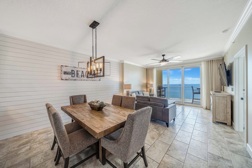 There is a dining table, perfect for enjoying a meal or playing a game, as well as additional breakfast bar seating.
