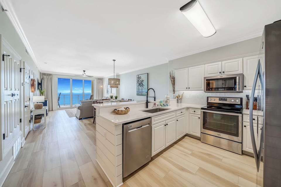 The fully equipped kitchen features quartz countertops, stainless-steel appliances, and has everything you need to prepare meals for family & friends.
