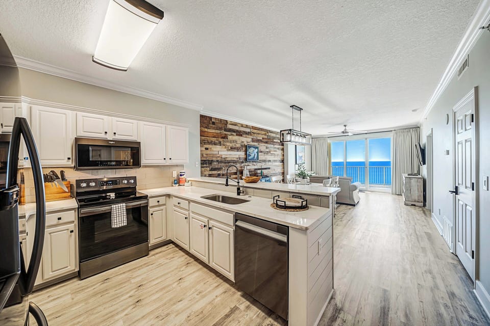 The fully equipped kitchen features quartz countertops, stainless-steel appliances, and has everything you need to prepare meals for family & friends.