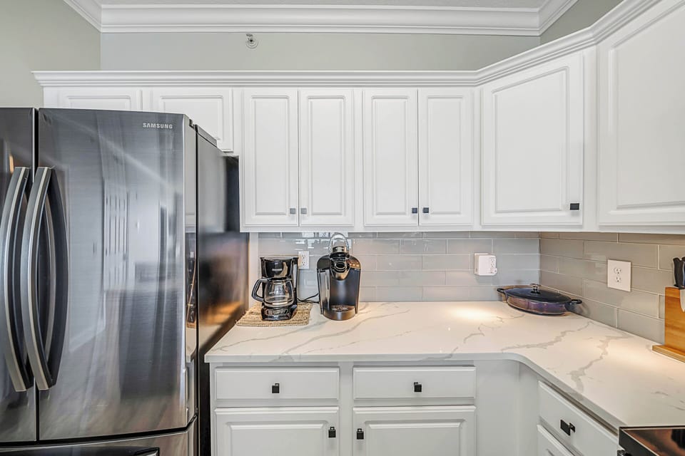 The fully equipped kitchen features quartz countertops, stainless-steel appliances, and has everything you need to prepare meals for family & friends.