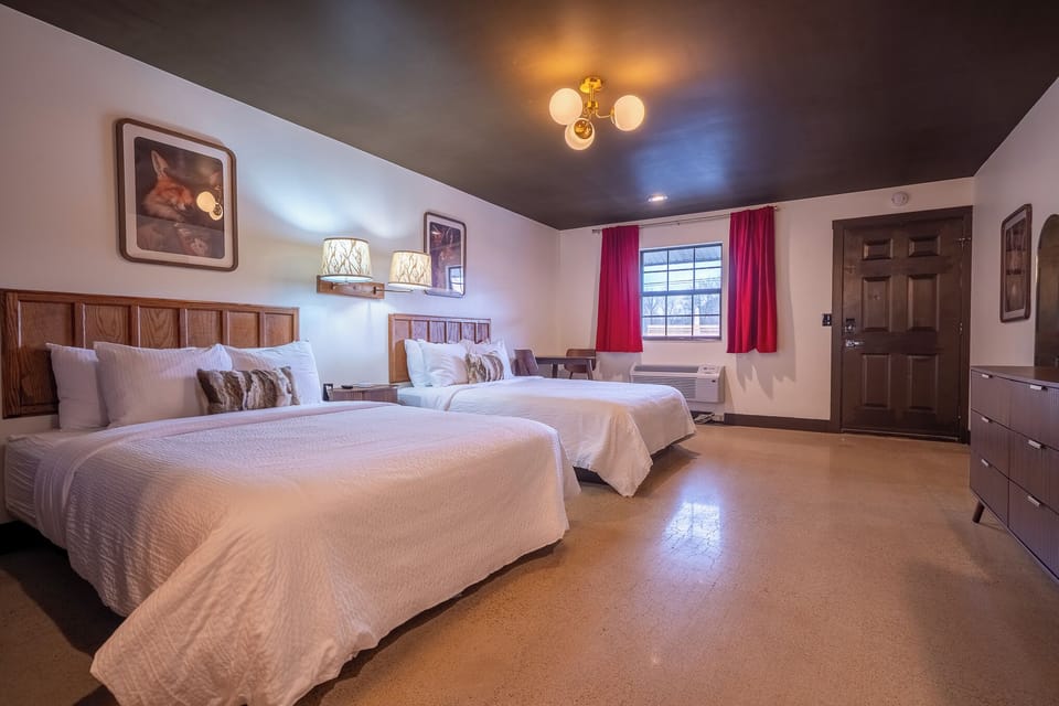 2 queen beds, table with 2 chairs, night stand with charging station