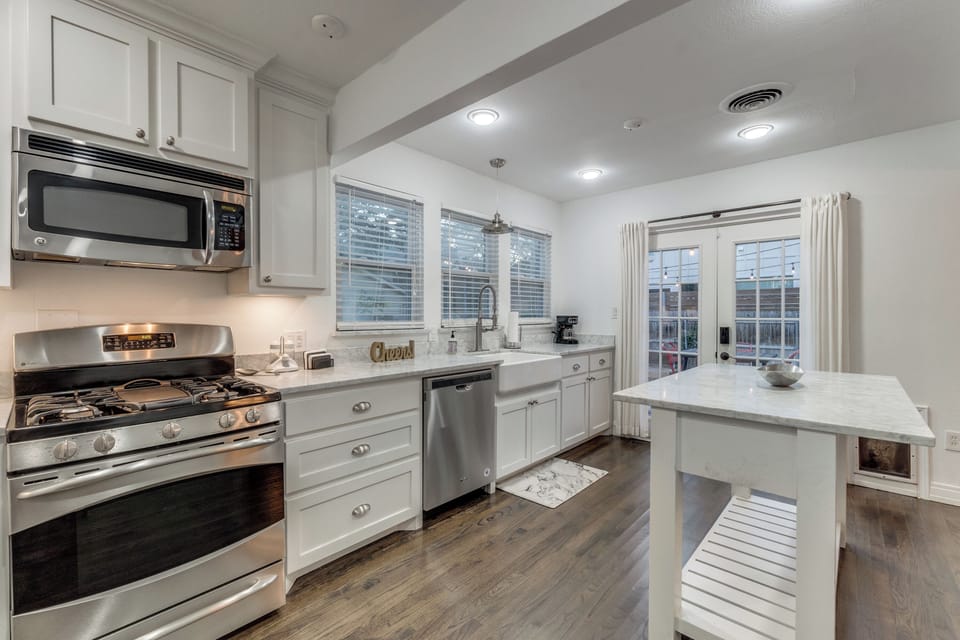 Your modern kitchen awaits with gleaming stainless steel appliances and bright marble countertops, perfect for creating memorable meals together.