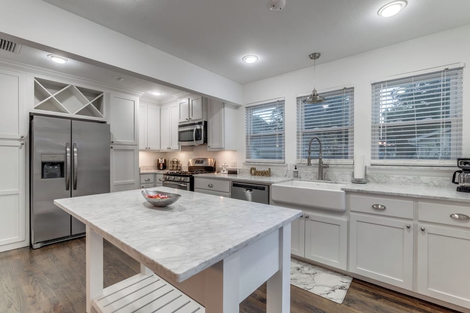 Your fully equipped modern kitchen features marble countertops, stainless steel appliances, and a spacious island perfect for preparing meals together.