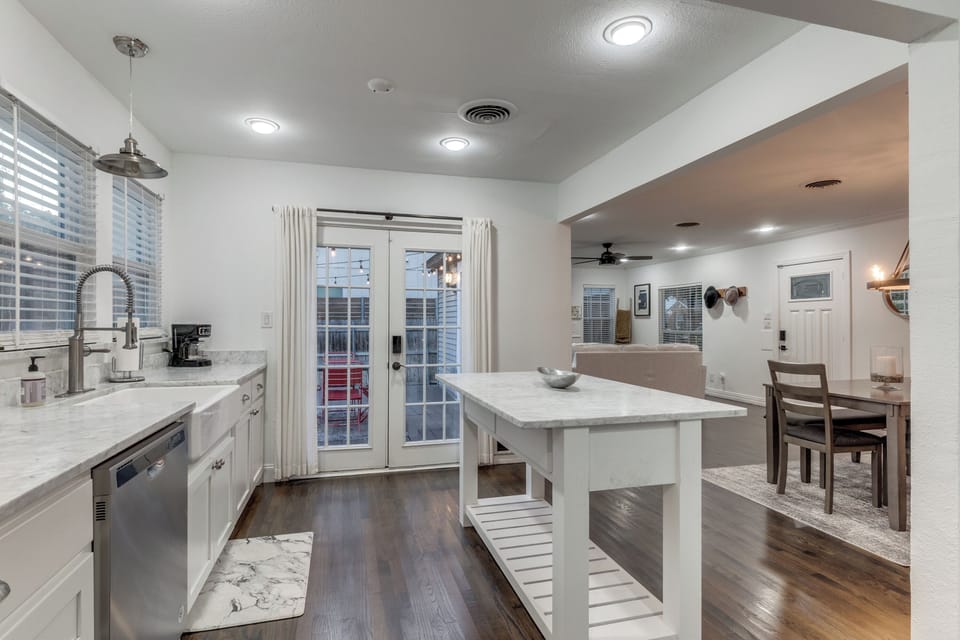 You'll love preparing meals in this bright, modern kitchen with marble countertops and a spacious island.