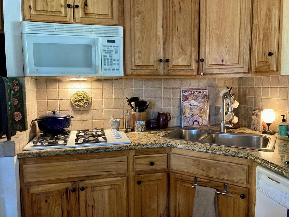 Kitchen (L-shaped, open to dining area), corner sink (new dishwasher installed)