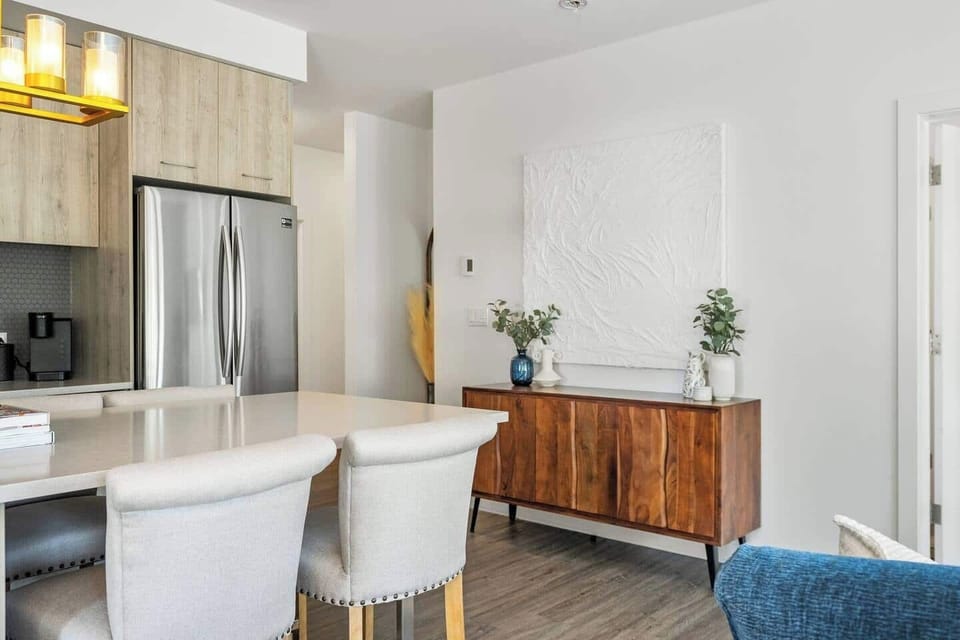 This stylish kitchen blends clean design with practical touches. Stainless steel appliances, warm textures, and calming decor make cooking feel effortless.