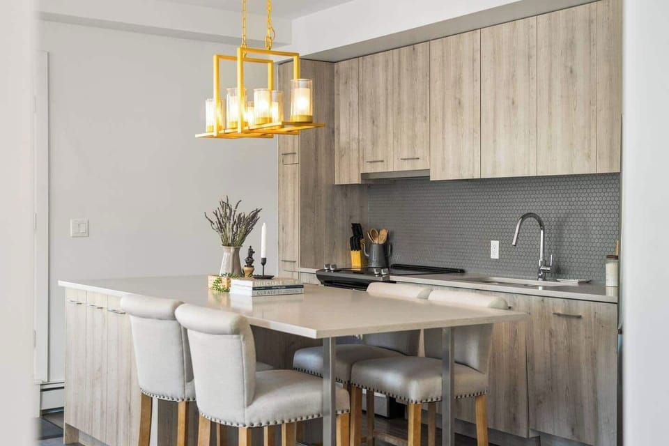 The spacious island doubles as a stylish dining area, perfect for enjoying meals or morning coffee, making it a centerpiece of the kitchen experience.