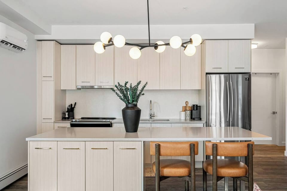 A chef’s dream kitchen featuring sleek cabinetry, modern appliances, and a spacious island with seating, perfect for cooking or gathering.