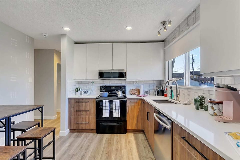 Whip up your favorite meals in this stylish, fully stocked kitchen featuring modern appliances, sleek cabinetry, and plenty of natural light to brighten your culinary experience.
