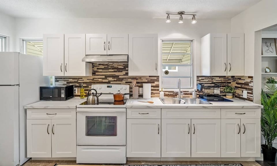 A bright and fully equipped kitchen featuring modern appliances, ample counter space, and everything you need to cook up your favorite meals.