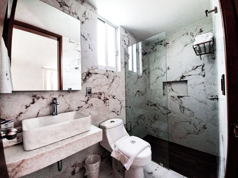 Separate tub and shower, towels, soap, shampoo