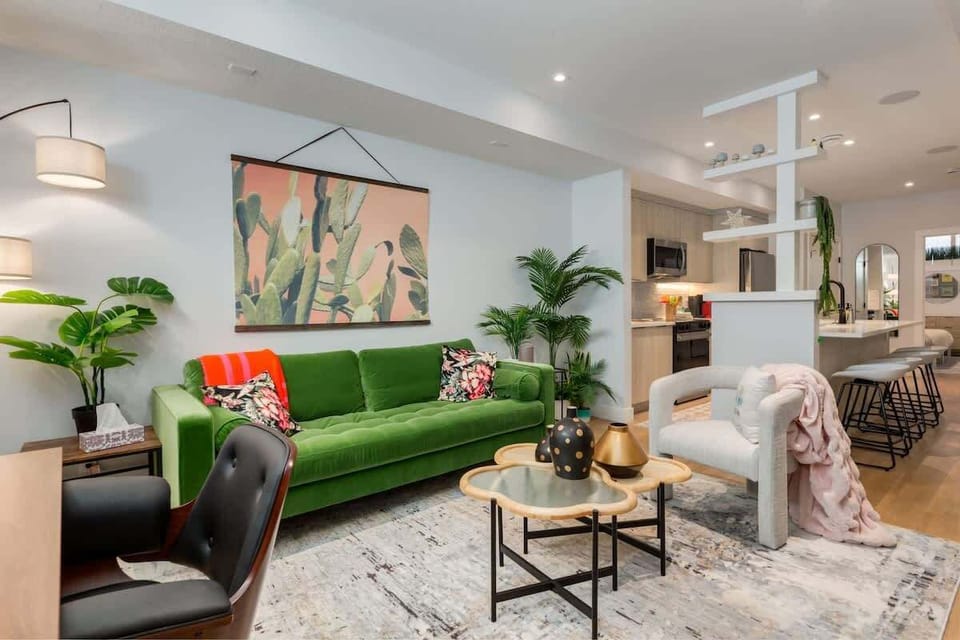 Lush living room wrapped in warm light and curated artwork
A sanctuary of texture and colour, blending velvet seating, soft neutrals, and a gallery-wall glow that makes the room feel instantly inviting.