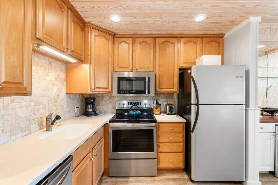 Whip up meals with ease in this stylish, stainless steel kitchen.