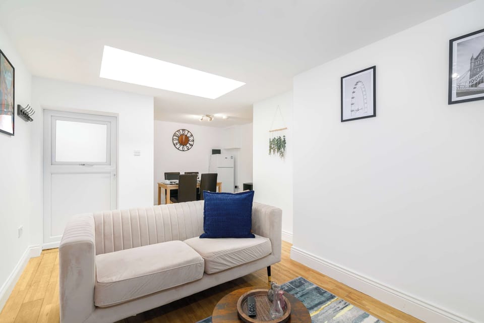 Bright open-plan living room with comfortable sofa seating — perfect for relaxing after exploring London