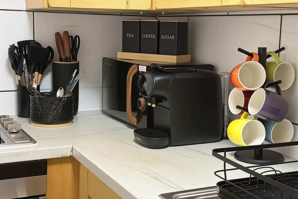Modern kitchen with oven, microwave, coffee machine and essentials for everyday cooking