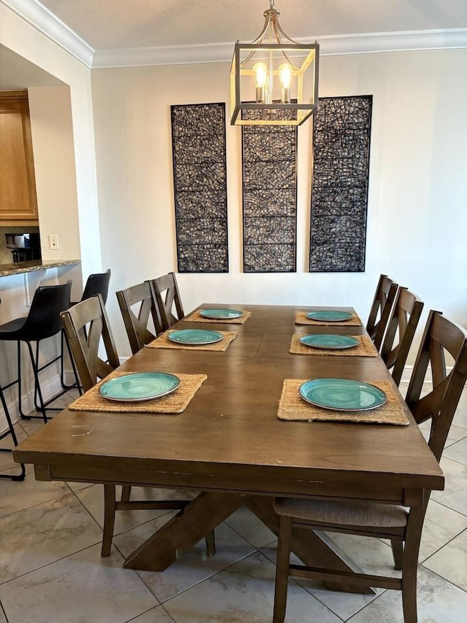Big dining table seats 6-8 people with 4 additional spots by the countertop