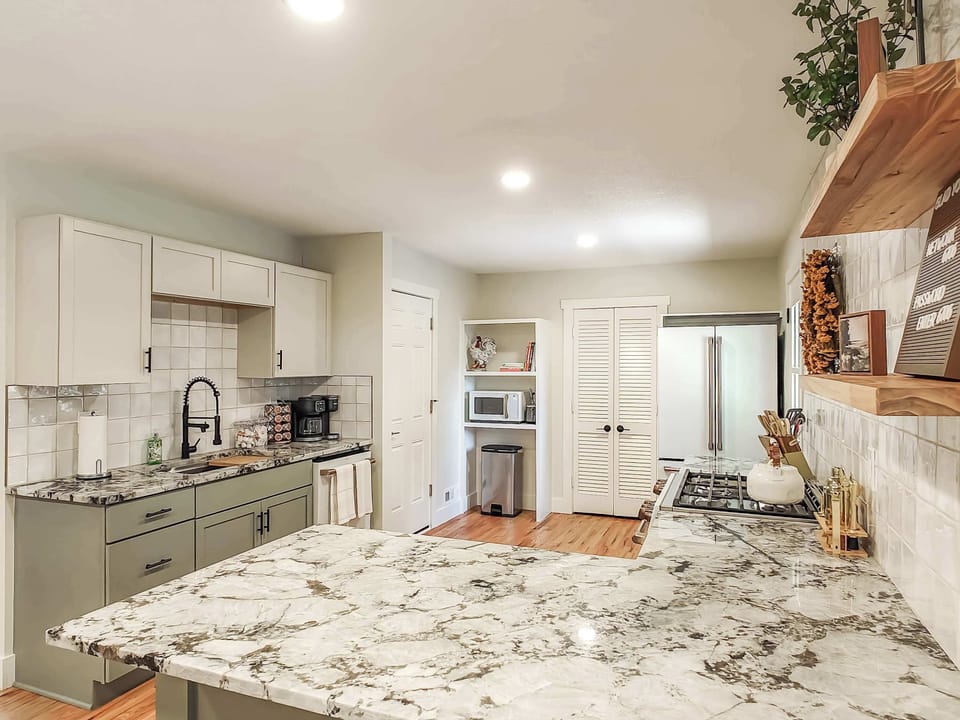Kitchen includes high-end stove/oven, large refrigerator, dishwasher and microwave