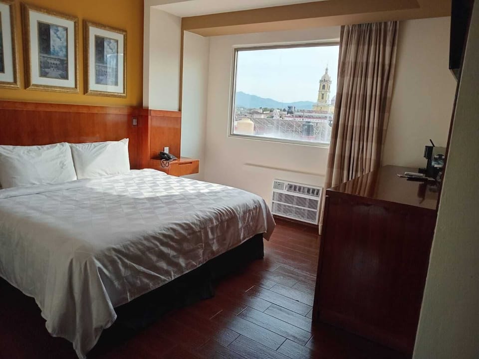 Premium bedding, laptop workspace, iron/ironing board