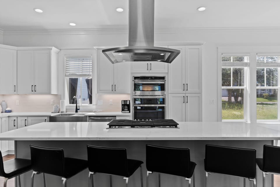 Enjoy a memorable gathering in your open-concept living space with a modern kitchen and bar seating.