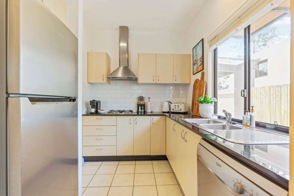Modern kitchen featuring quality appliances and generous bench space