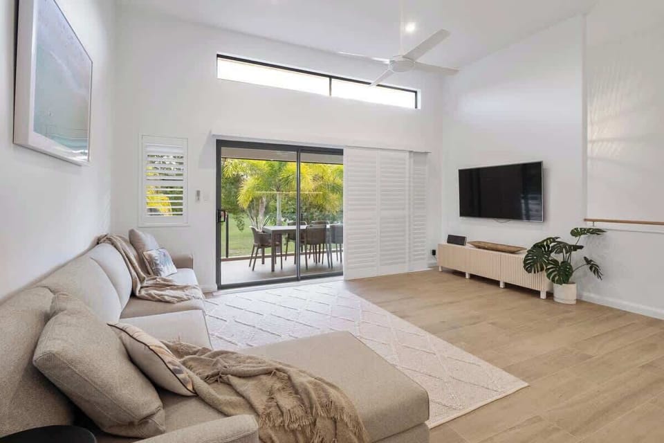 Spacious living area leading to outdoor dining and kitchenette. 