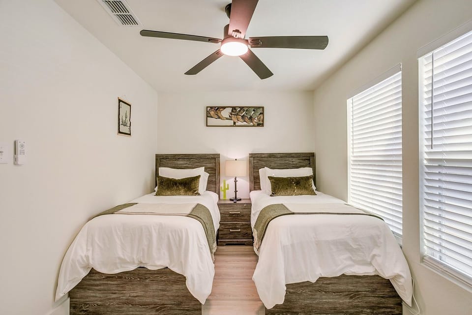 Thoughtfully designed twin bedroom with Smart TV and blackout blinds for restful sleep — ideal for families or group getaways.
