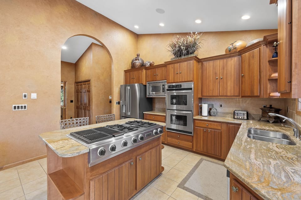 The center island has an 8 burner gas cook top for ease and convenience. 