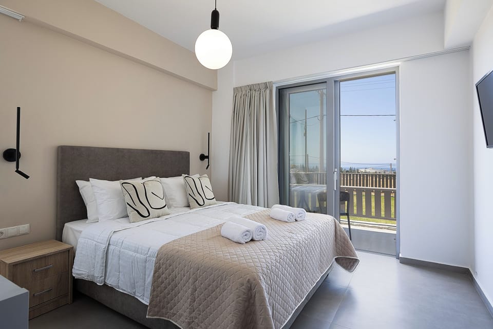 Garden-facing balcony and plush double bed on the ground floor