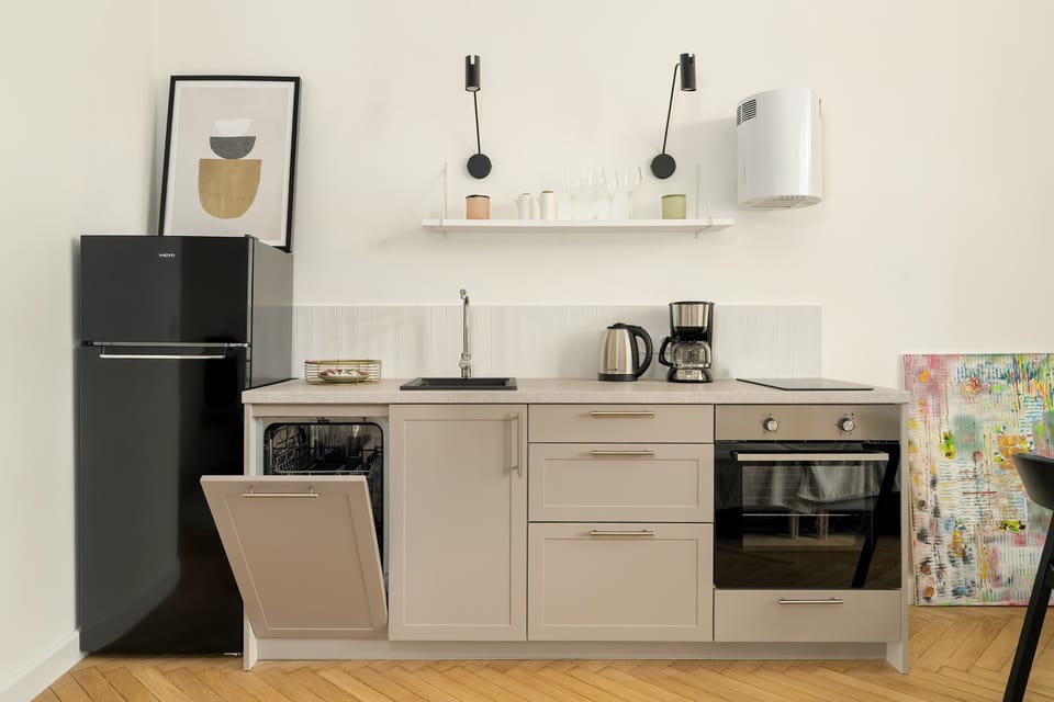 A functional kitchen with a large fridge and oven makes longer stays and cooking complete meals easier.