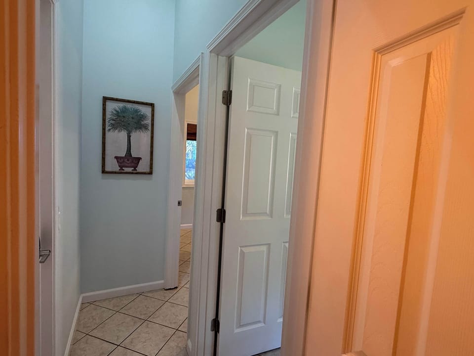 View from the Royal Suite private bathroom into the private hallway that leads to the king bedroom, the suite's private living room/kitchenette & exit into the shared lobby/lounge.