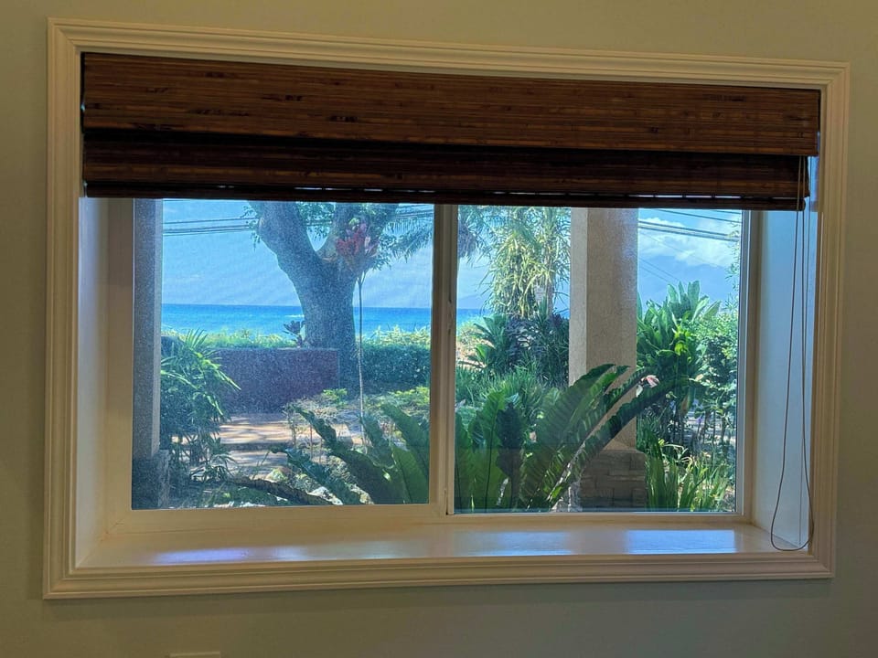 Royal Suite with King Bed offers views of the ocean, garden and island of Molokai with AC comfort. 