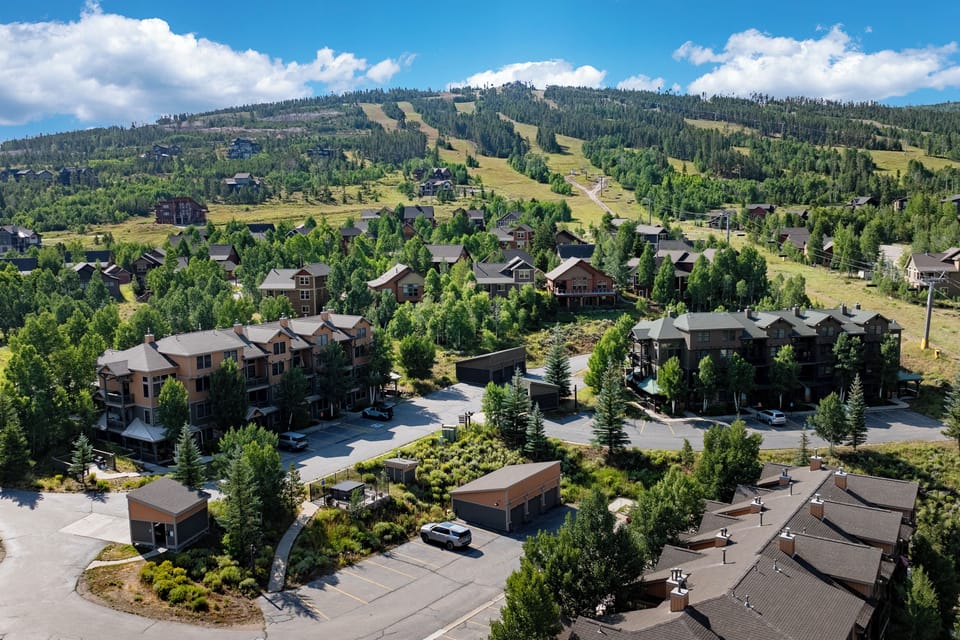 Kicking Horse Maverick 5-203 is a mountain resort townhomes nestled among trees with scenic hill views and convenient parking access.