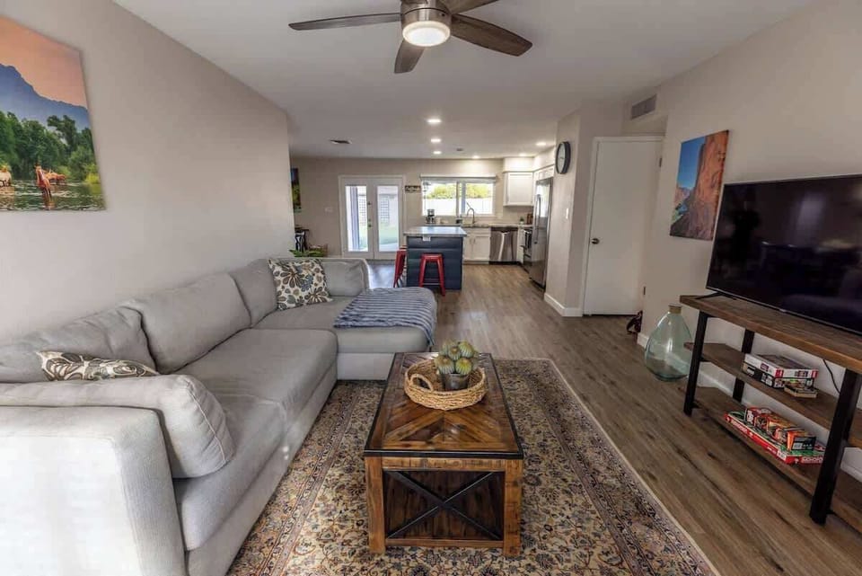 Bright living room with comfy seating and TV.