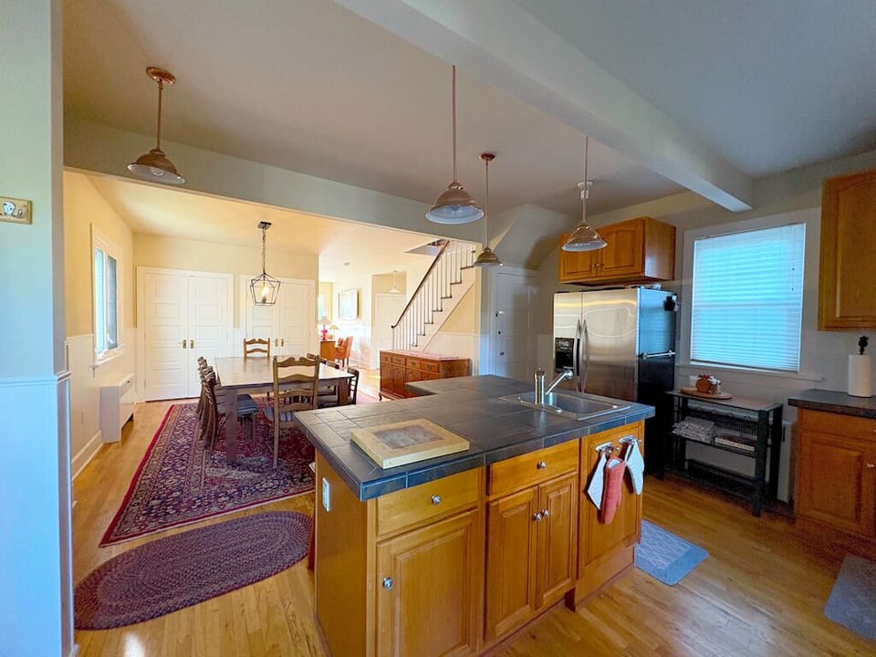 View of dining room from kitchen.  Island features two stools for chatting!