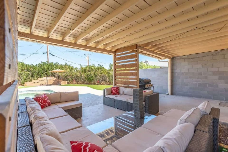 Covered patio lounge for slow evenings—stretch out on the cushioned sectional, then fire up the grill right beside you for a smoky meal before settling back in the shade.