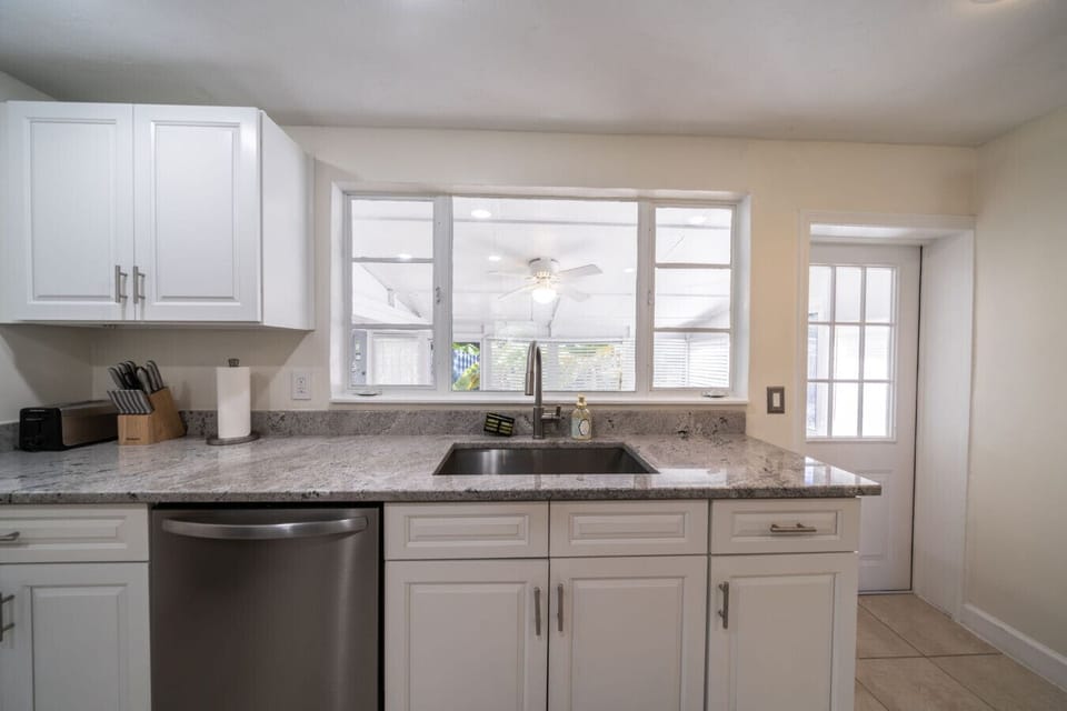 Kitchen: Modern appliances and sleek countertops for your cooking adventures in sunny Fort Myers!