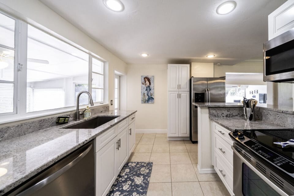Kitchen: Modern appliances and sleek countertops for your cooking adventures in sunny Fort Myers!