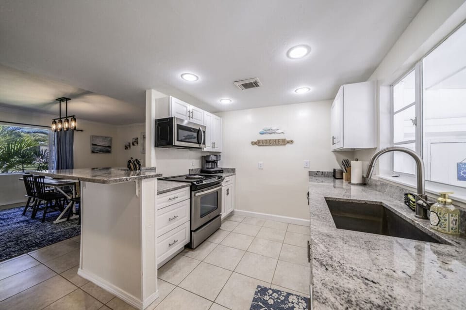 Kitchen: Modern appliances and sleek countertops for your cooking adventures in sunny Fort Myers!